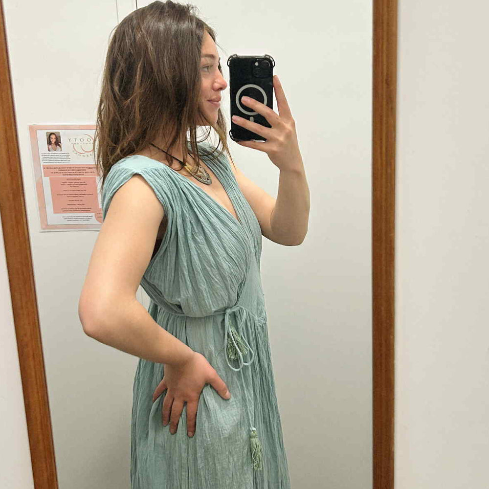 
                  
                    Load image into Gallery viewer, Woman taking a mirror selfie wearing a light green dress in a room with a wooden frame.
                  
                
