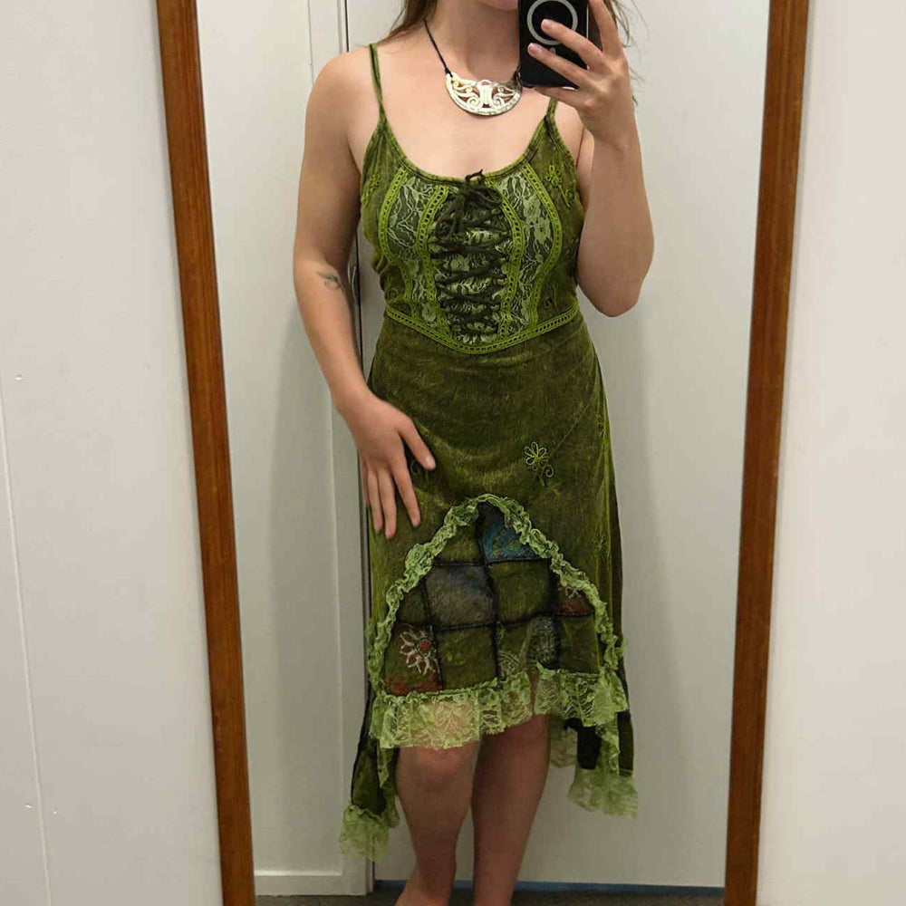 
                  
                    Load image into Gallery viewer, Woman wearing a green lace dress standing in front of a mirror.
                  
                